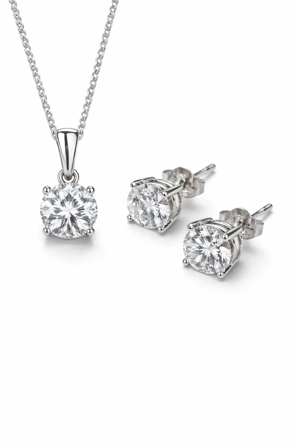 Diamond pendant necklace and stud earrings in white gold